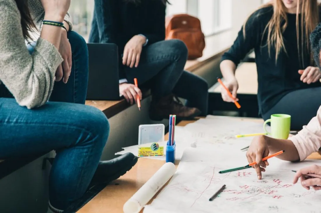 Professionals working together over notes at a table